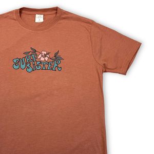 Pink t-shirt with 'Surf Sister' text and floral design on a white background